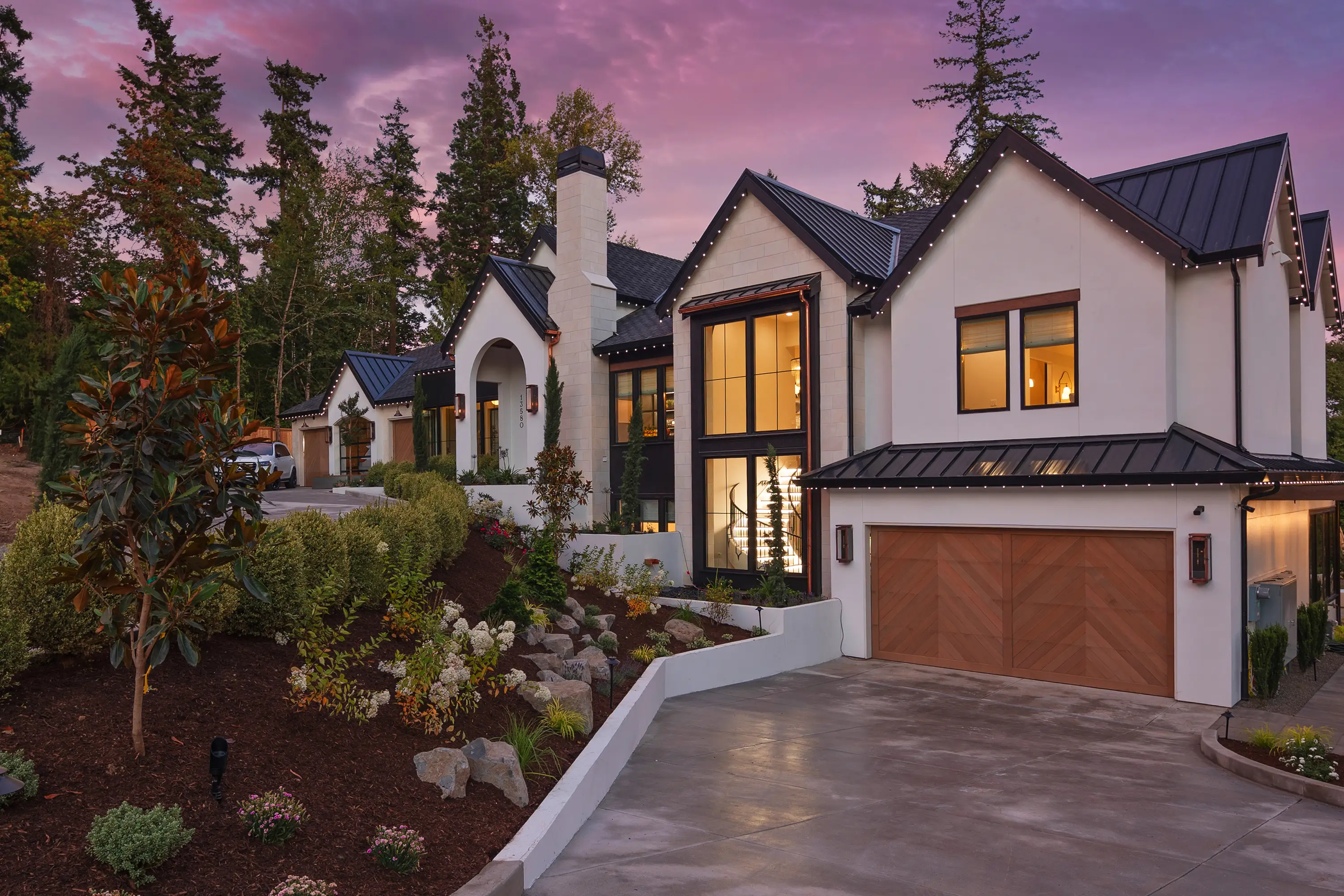 Alla Famiglia — European-style Street of Dreams home in Lake Oswego at twilight, designed by Greylyn Wayne