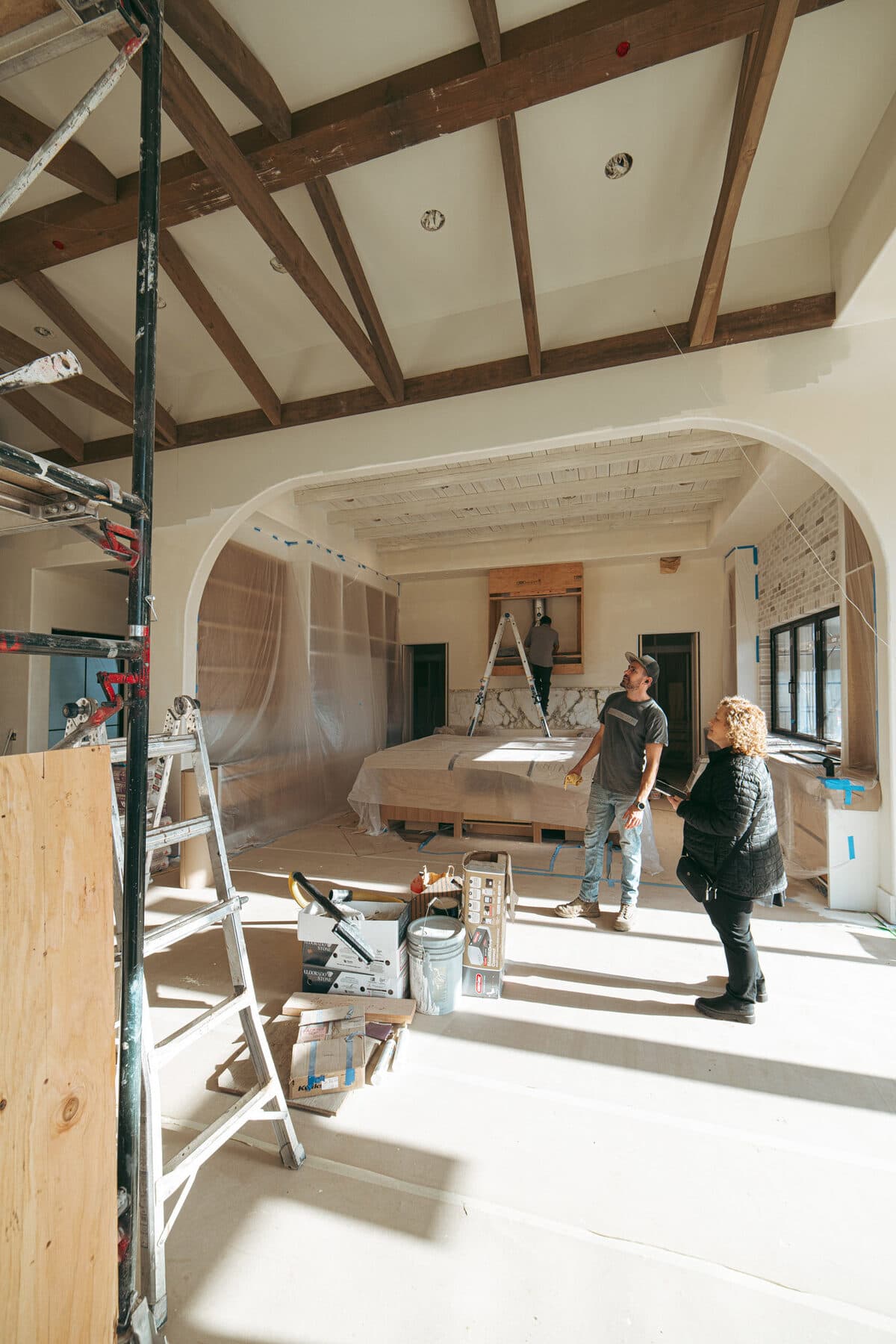Alla Famiglia — grand entry hall with arched doors, European oak floors, and rustic beamed ceilings