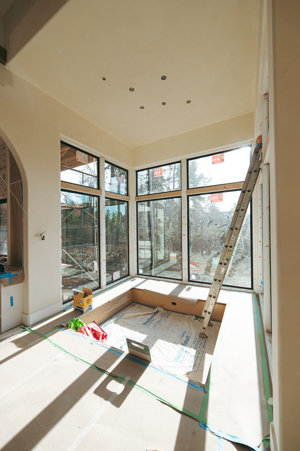 Alla Famiglia — dramatic 30-foot window wall framing the spiral staircase